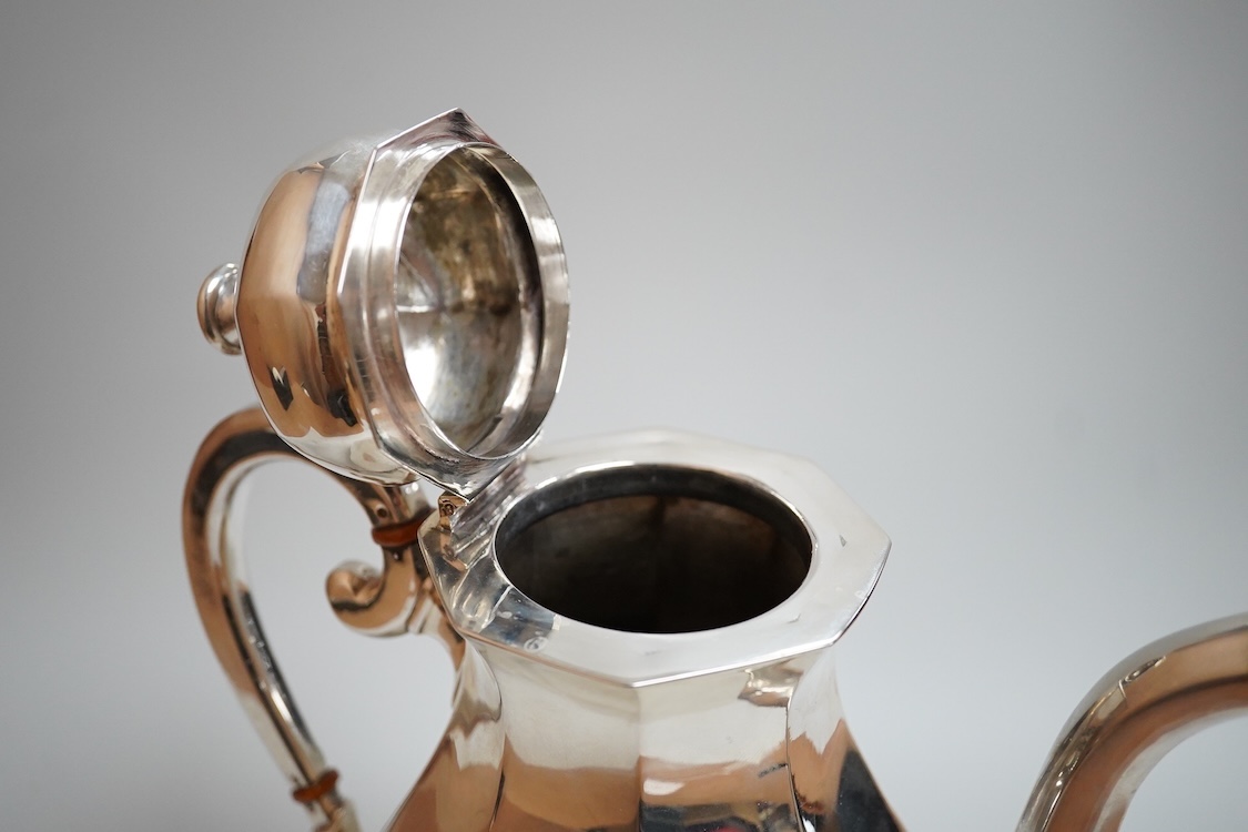A white metal octagonal coffee pot with hinged cover, (tests as a low grade silver), on octagonal foot, height 23cm, gross weight 21oz.